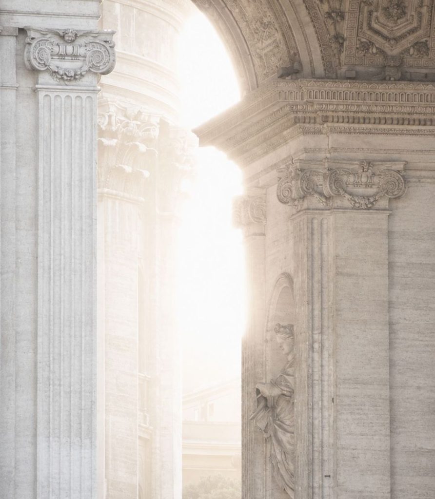 Bright light falling through a classical stone archway